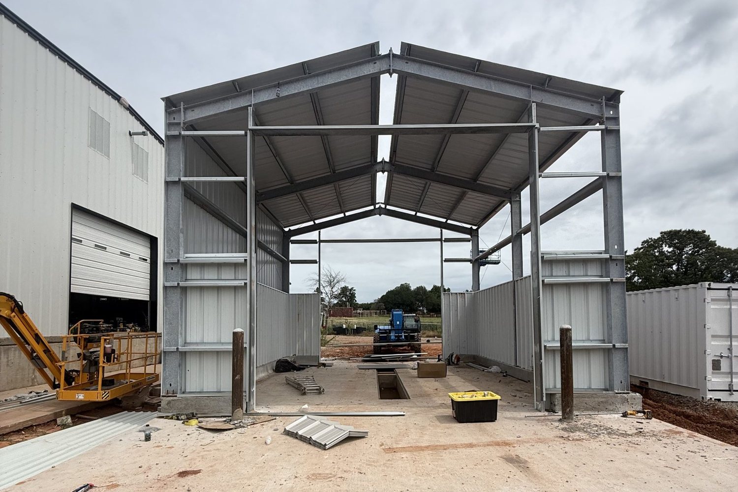 Framed metal building with roof panels set